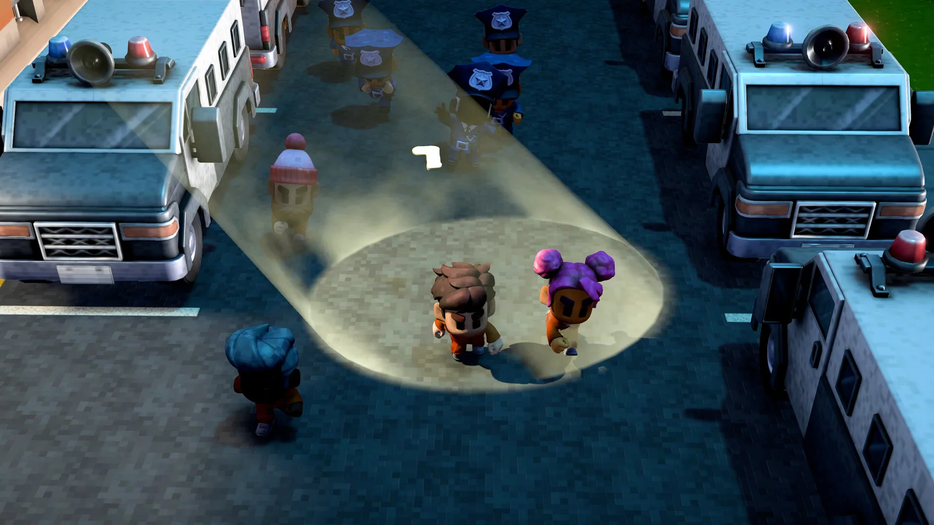 Official The Escapists 3 screenshot showing two inmates in orange jumpsuits caught in a searchlight beam on a dark street at night while guards pursue them beyond the prison walls
